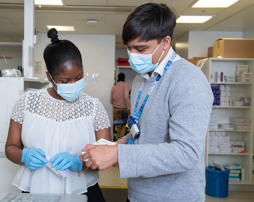 two pharmacists holding medicines